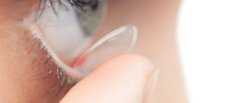 extreme-close-up-pretty-model-applying-contact-lens price of contact lens with power - oswal eye care