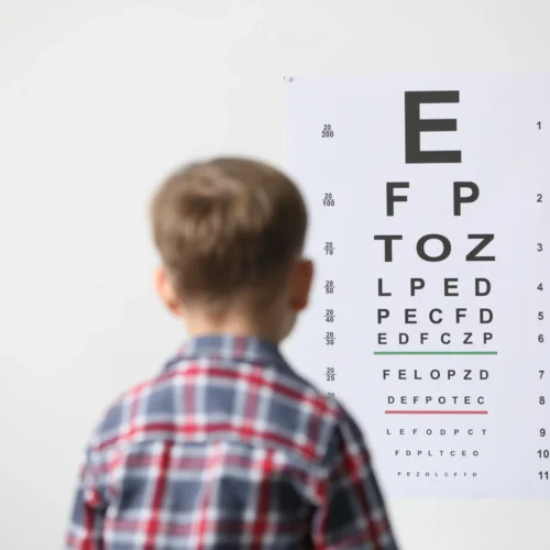 eyesight-examination-little-boy-looking-vision-test-chart-indoors-back-view eye checkup doctor - oswal eye care